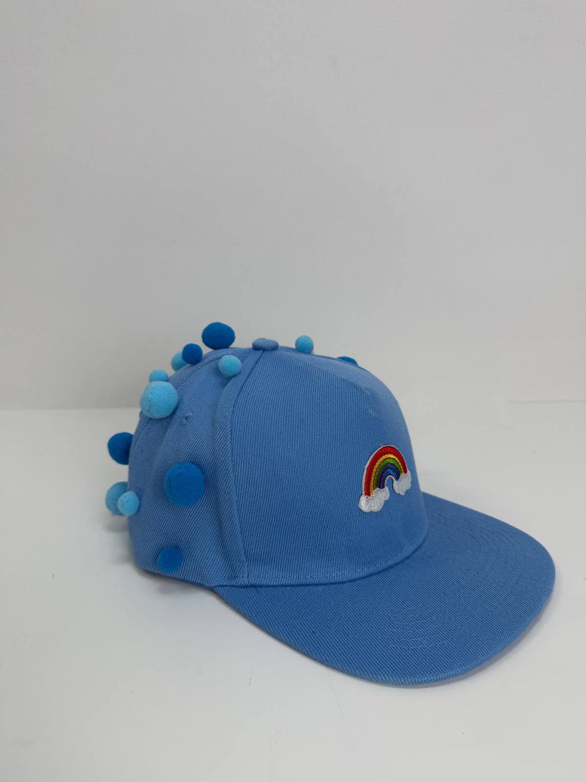 Gorra Rainbow Azul — Rainbow Factory, de perfil